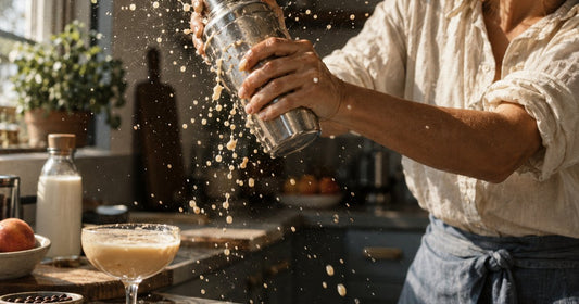 Flat lay of the paste method for mixing protein coffee — a stirred paste, a smooth finished glass and a frother