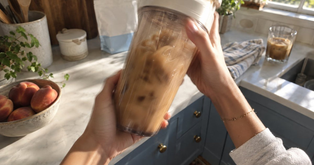 Pale protein being poured into a glass of iced coffee, showing how proffee is made
